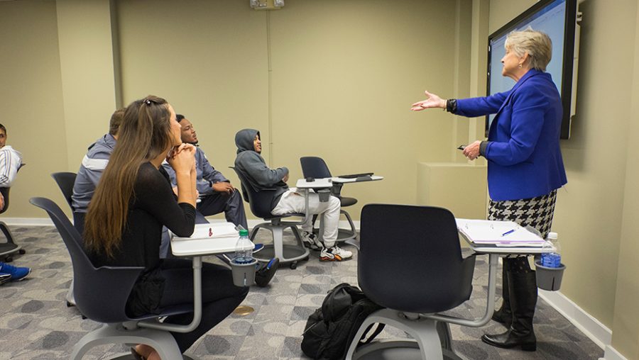 Photo of Dr. Anita Gustafson lecturing a class.