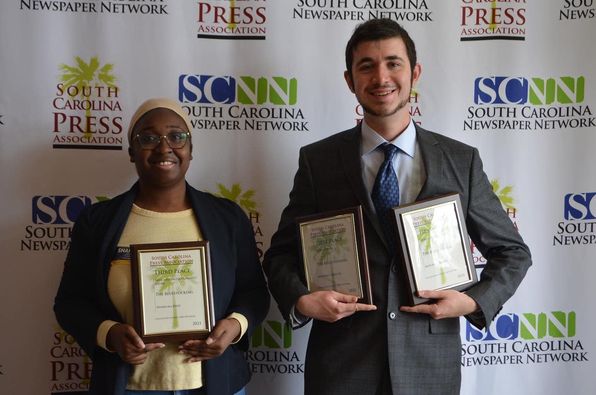 Sharecka Byrd and Mitchell Mercer proudly holding up their South Carolina Press Association Awards.