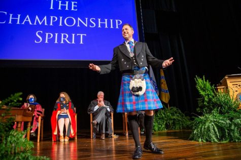 Dr. Matthew vandenBerg sports the traditional Presbyterian College tartan as a packed crowd of well-wishers in Belk Auditorium welcomes him to his now-official role as the 19th president of the Clinton, S.C., school. In the background, from left, are Dr. Joy Smith, vice president for campus life and dean of students, Dr. Kerry Pannell, provost and vice president for academic affairs, and E.G. Lassiter, ‘61, chairman of the board of trustees.
