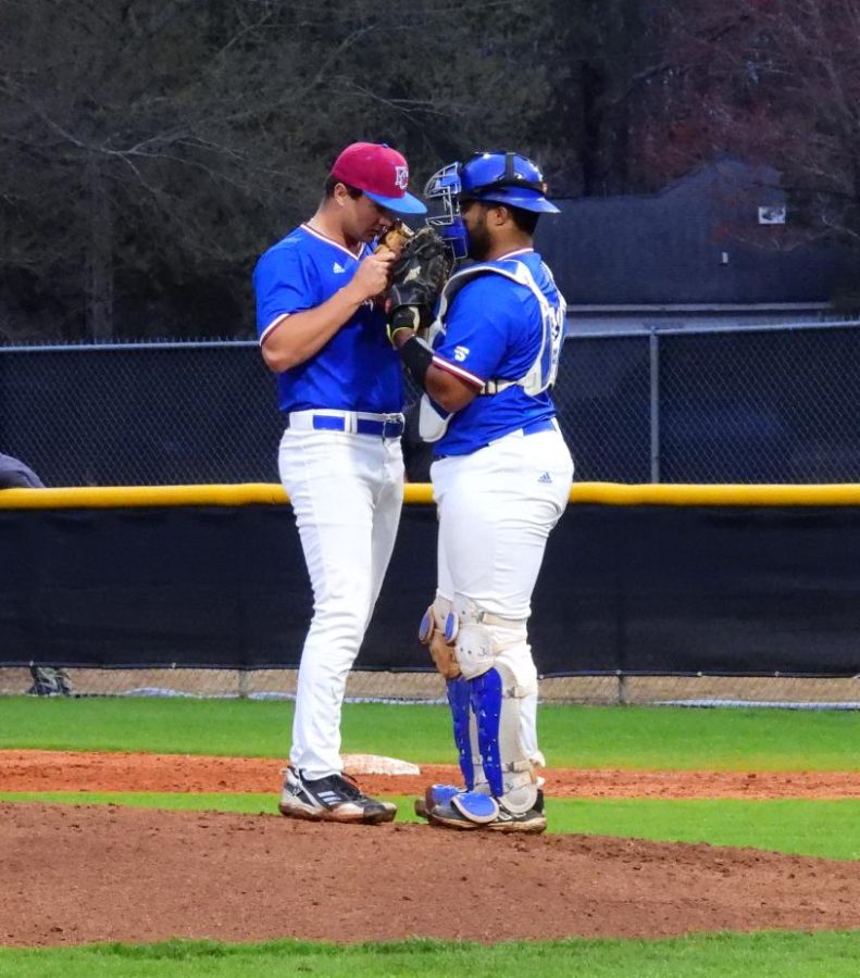 Catcher Jeremiah Boyd talks to the pitcher at the mound. 
