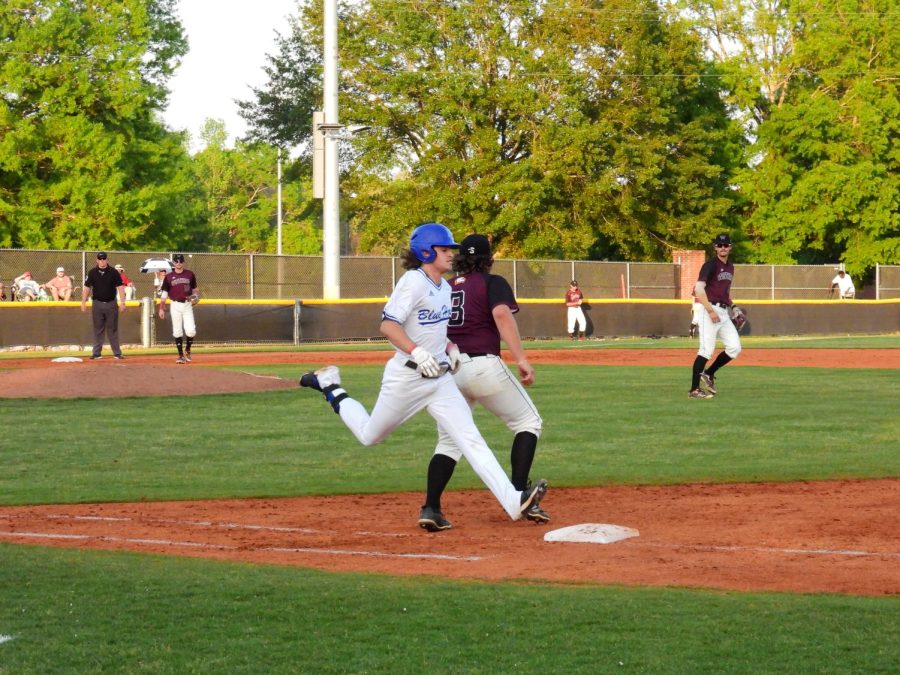 A Blue Hose runner edges to get to first base in time.