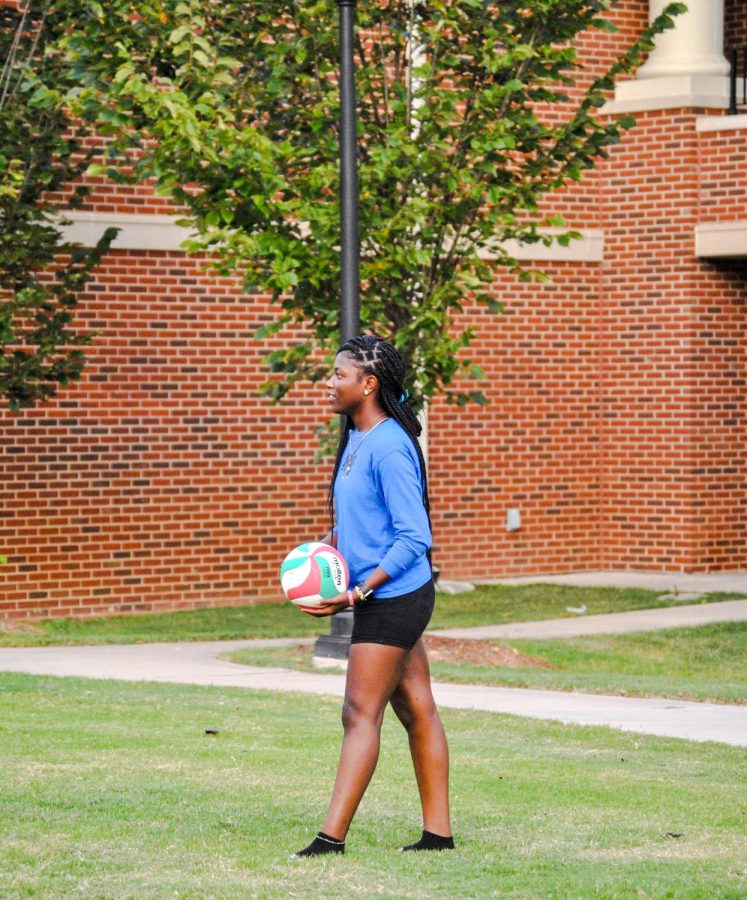 An intramural volleyball player enjoys her time playing.