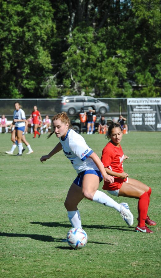 Lauren Clark passes her opponent as she takes the ball up the field.