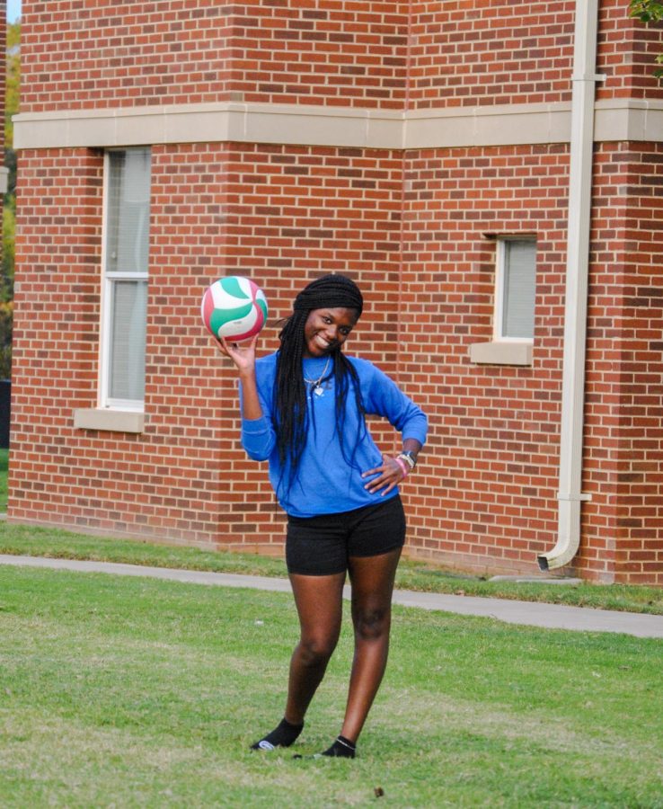 An intramural volleyball player smiles at the camera.