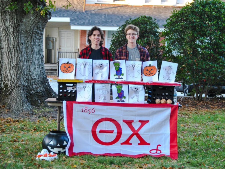 Theta Chi members taking a picture with their decorated table.