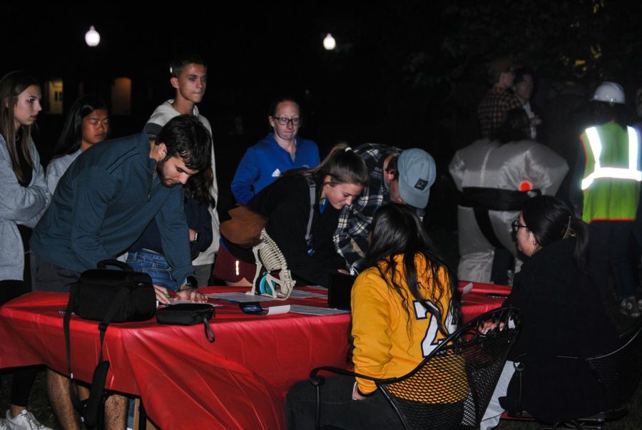Students signing up to walk the haunted trail by the RA staff.