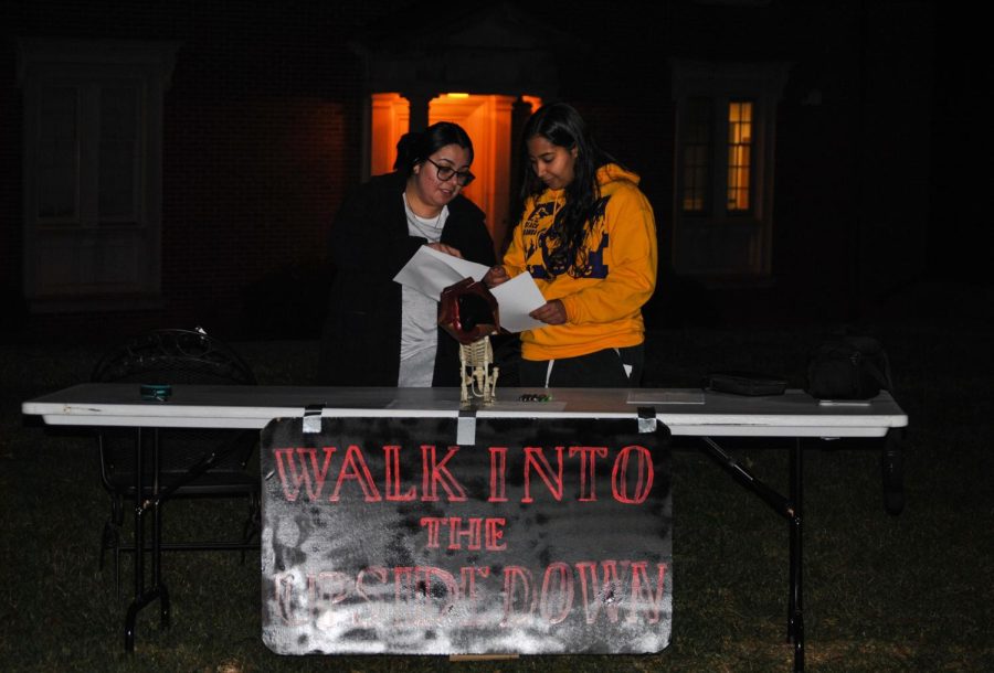 RA staff working at the table for sign ins for the haunted trail.