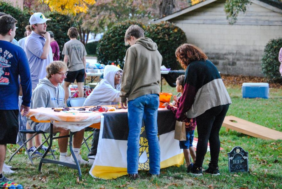 Members of Sigma Nu giving out candy to residents of Thornwell.