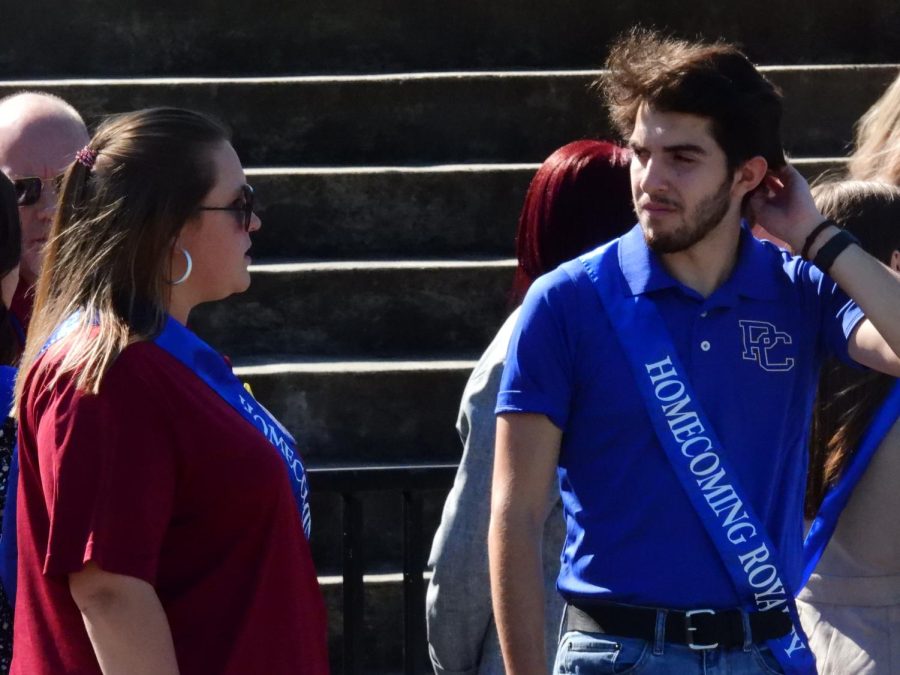 Homecoming court finalists Mary-Charlotte Dusa and Ralph Guerra chat with each other.