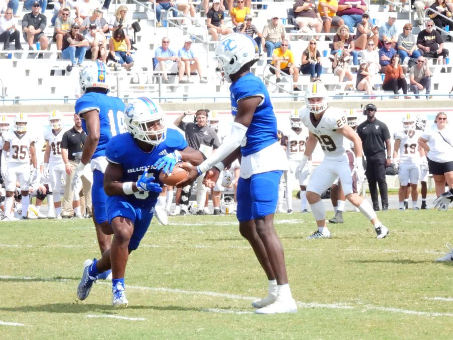 Wesley hands the ball off to running back Delvecchio Powell II.