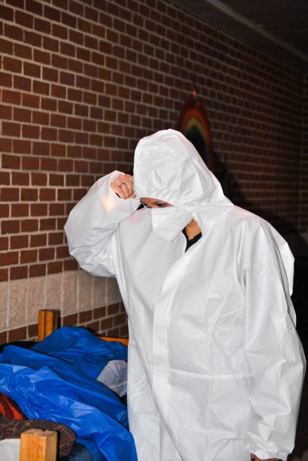 Dessa Jones in a hazmat suit, scaring the students in the haunted trail.