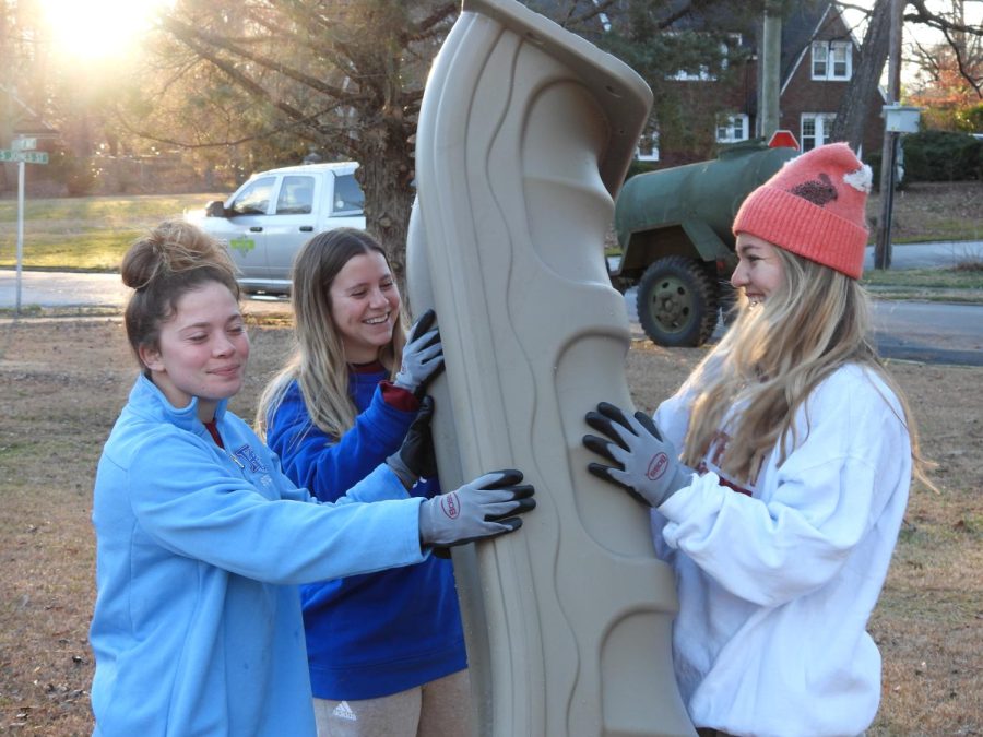 Members of the Blue Hose womens soccer team work together on building the playground.