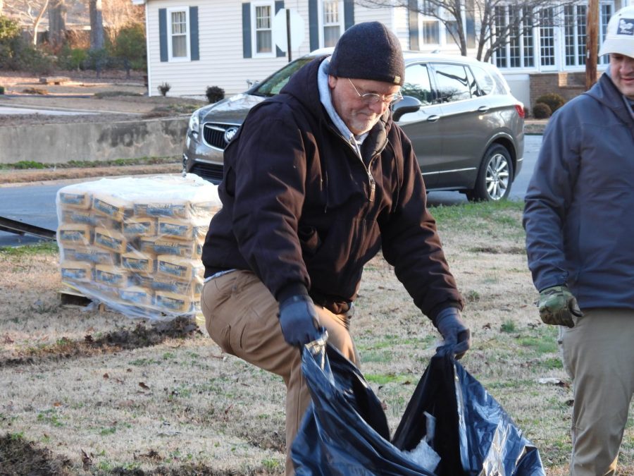 Blue Hose womens soccer coach Brian Purcell (87) collects trash.