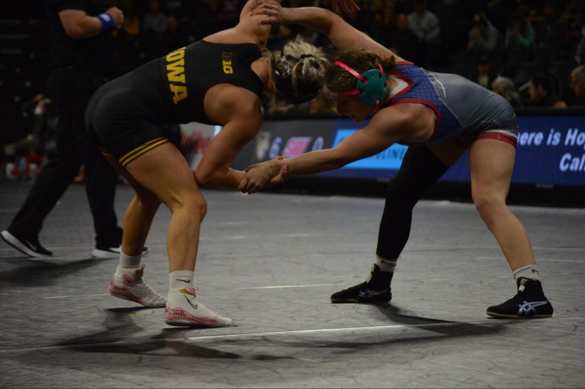 At 123 lbs, Alyssa Mahan of the Blue Hose grapples with Felicity Taylor of the Hawkeyes to improve her position
