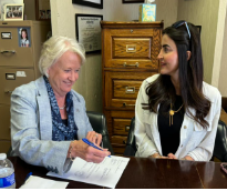 Dr. Anita Gustafson (left) and Narmeen Abojamoos (right) negotiating a deal.