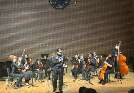                                                                                     Conductor Dr. Giovanni Briguente on mic, detailing his amazing concert